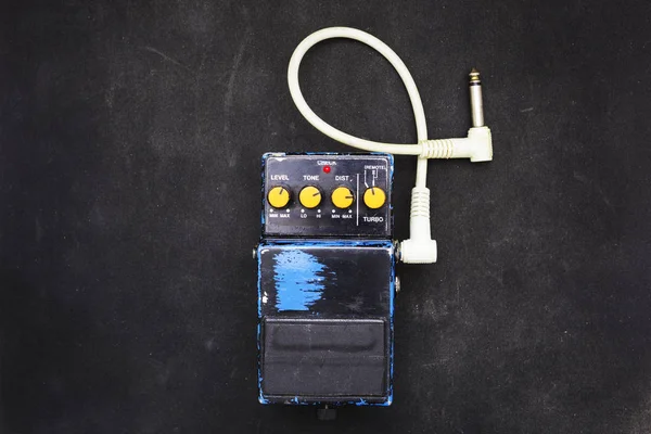 Vintage guitar effect pedal on dirty surface — Stock Photo, Image