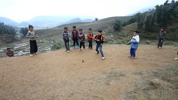 Σάπα - 01 Δεκεμβρίου 2016: Τα παιδιά εθνικής μειονότητας παίζει ένα παιχνίδι με σβούρες, σε μια αγροτική περιοχή κοντά σε Σάπα. — Αρχείο Βίντεο