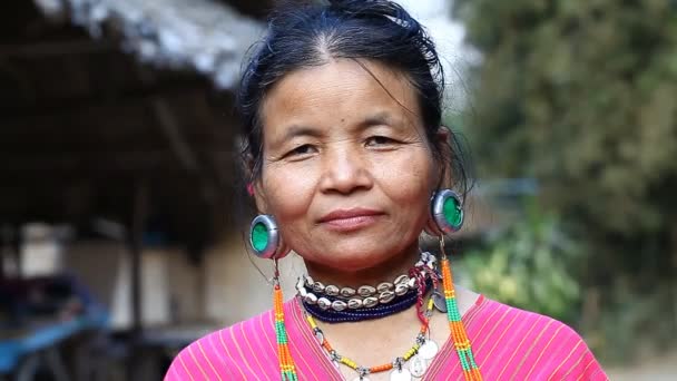 Chiang Mai,Thailand-February 13 ,2017:Video portrait of an adult woman with tunnels in the ears from the hill tribe Kayaw living in Eco-Agricultural Hill Tribes Village - Baan Tong Luang. — Stock Video