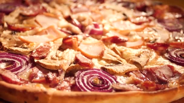 Close-up juicy Italian pizza. Warm lighting and camera slow motion. — Stock Video