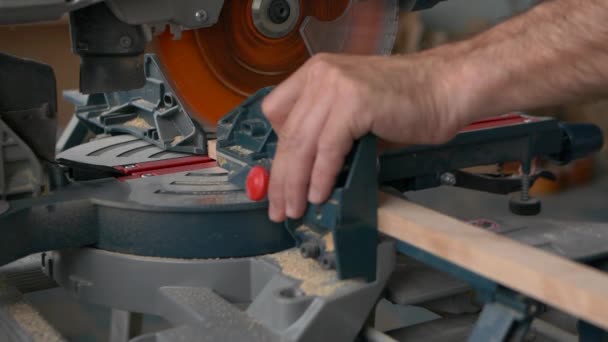 A carpenter works on a circular electric saw. A close-up of the hands of a worker and machine parts. Slow motion footage. — Stock Video