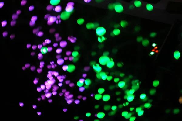 Blurred LED screen closeup. Glowing threads in a color spectrum on a black background.
