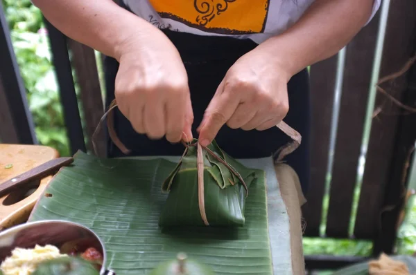 La femme l'utilisation de matériaux naturels de bananiers Utilisé pour fabriquer des emballages pour les aliments . — Photo