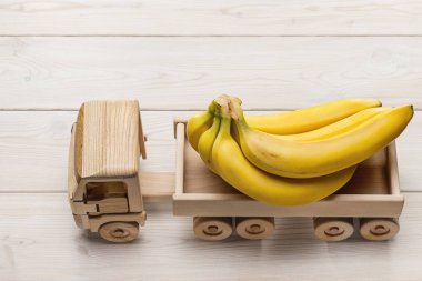 Salkım muzu ahşap arka plan üzerinde izole kamyon.