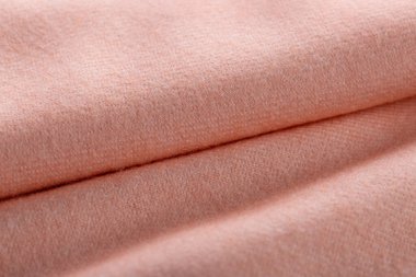 Kaşmir kumaşın arka plan dokusu. Şal, atkı soluk turuncu. Moda renklerinde zarif tekstil arkaplanı.