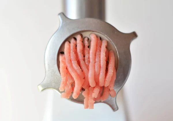 Minced meat in a meat grinder.