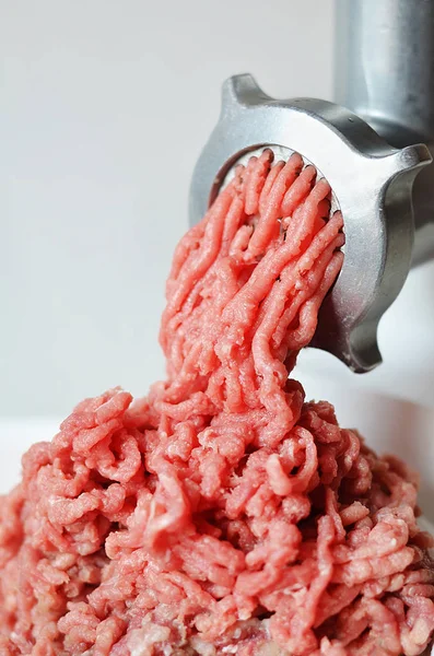 Minced meat in a meat grinder.