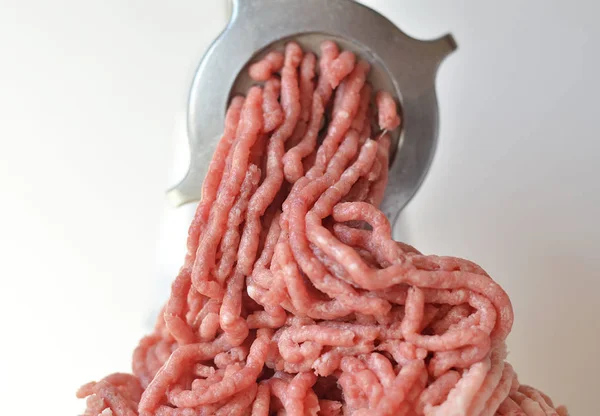 Minced meat in a meat grinder.