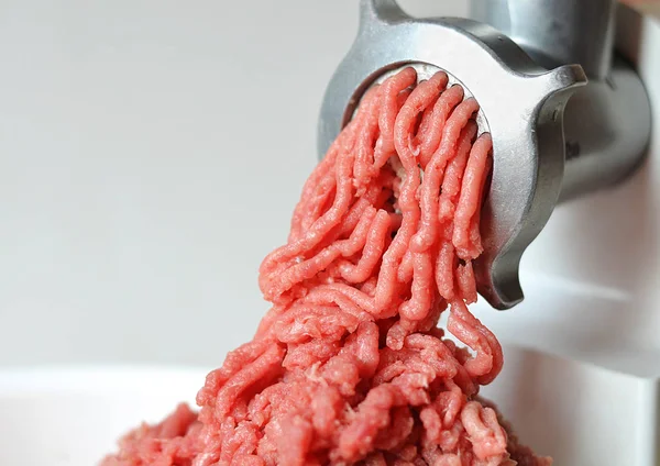 Minced meat in a meat grinder.