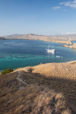 The arid islands found within Komodo National Park, Indonesia, are surrounded by beautiful coral reefs. This tropical area is known for its Komodo dragons and its spectacular marine biodiversity. clipart
