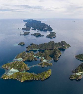 Seen from above, limestone islands stretch into the distance near Misool, Raja Ampat, Indonesia. This biodiverse region is known as the 