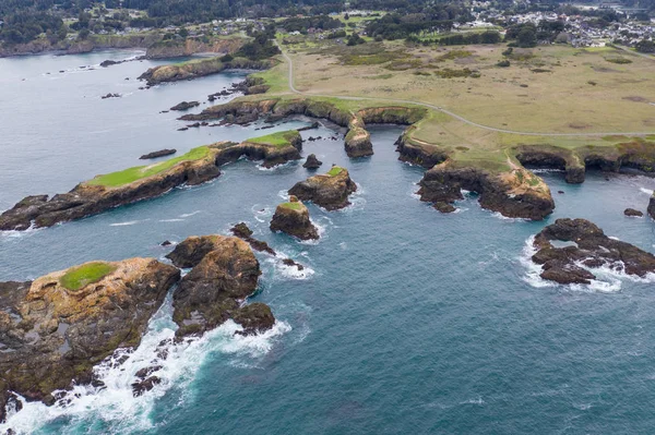 The cold waters of the Pacific Ocean wash against rocks off the rugged Northern California coastline in Mendocino. This scenic coastal area lies north of San Francisco by a few hours drive.