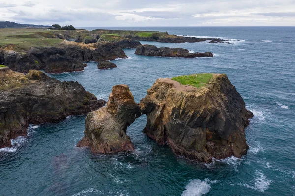 The cold waters of the Pacific Ocean wash against rocks off the rugged Northern California coastline in Mendocino. This scenic coastal area lies north of San Francisco by a few hours drive.