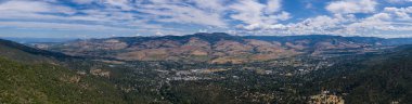 Seen from a bird's eye view forest covers the hills surrounding Ashland, a quaint city in southern Oregon. This area is known for mountain biking and the Oregon Shakespeare Festival. clipart