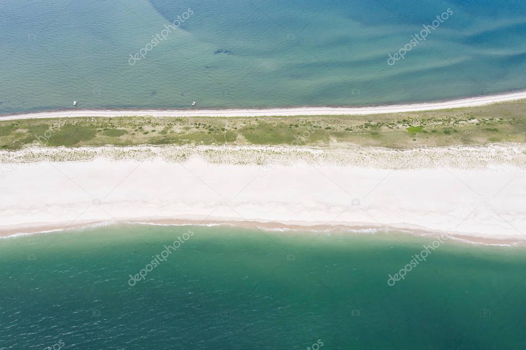The cold waters of the Atlantic Ocean bathe a scenic beach on Cape Cod, Massachusetts. This beautiful area of New England, not too far from Boston, is a popular summer vacation destination.