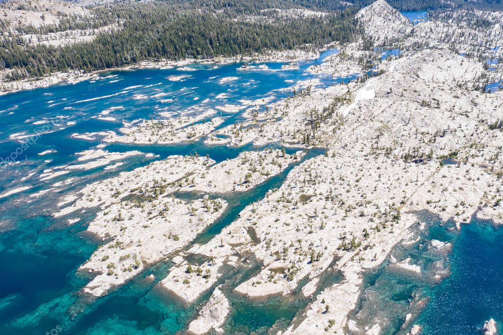 The Sierra Nevada mountains in California are made up of 100 million year old granite that were sculpted by glaciers. The mountain range includes 3 national parks and 20 wilderness areas.