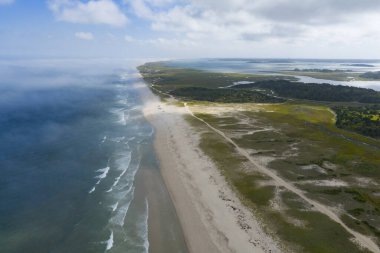Bulutlar, Orleans, Cape Cod, Massachusetts 'teki Nauset Sahili' nin üzerinde sürükleniyor. Bu estetik halk plajı yaz aylarında tatil yapan insanlar için popüler bir yerdir.. 