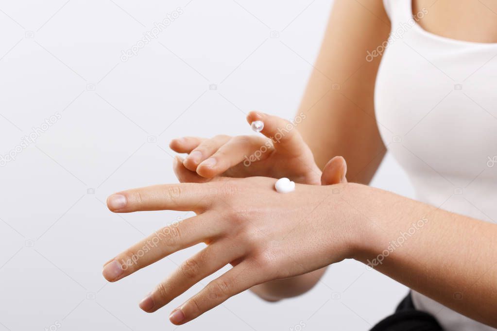 Hand Skin Care. Women use body lotion on your arms. Female applying cream to her hands