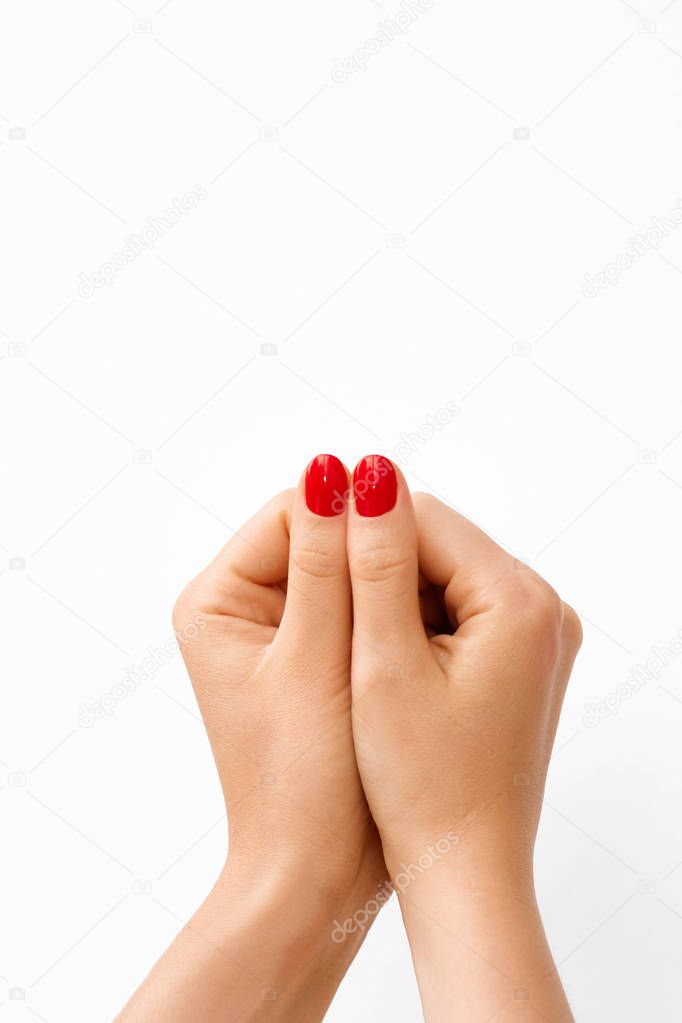 Photo of a Woman's Hands Showing Big Fingers with Red Manicure. 
