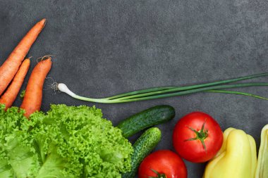 Siyah arka plan, üst görünüm, afiş üzerinde sağlıklı pişirme için taze malzemelerle Çiğ organik sebze seti. Vegan veya diyet gıda kavramı. Boş metin alanı içeren arka plan düzeni.