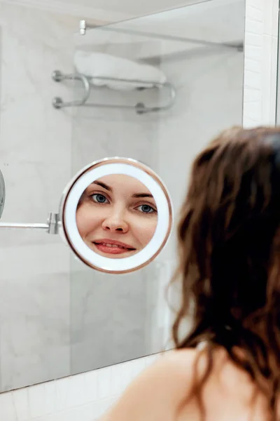 Cuidado Com Pele Mulher Tocando Cabelo Sorrindo Enquanto Olha Espelho — Fotografia de Stock