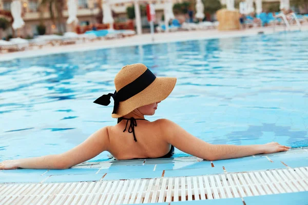 Summer Beauty Woman Body Care. Beautiful Sexy Girl With Healthy Skin In Elegant Striped Bikini, Sun Hat Relaxing In Swimming Pool Water In Resort Spa Hotel On Travel Holidays Vacation. Enjoyment. Lifestyle