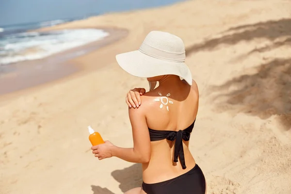 スキンケア 太陽の保護 美しい女性は顔に日焼け止めクリームを塗ります ビーチで日焼けローションを持つ女性 保湿日焼け止めを持つ女性の肖像 女の子は彼女の肌に日焼け止めを使用しています — ストック写真