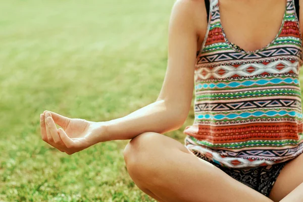 Close up hands. Woman do yoga outdoor. Woman exercising vital and meditation
