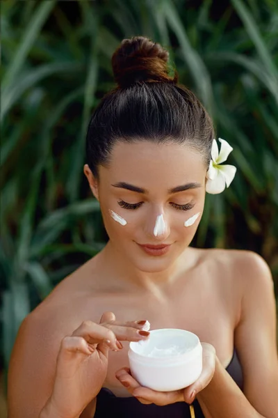 Skin care.Beauty Woman Concept. Young pretty woman holding cosmetic cream