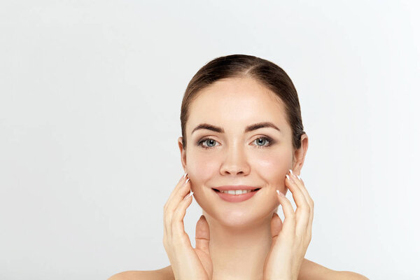 Beautiful Young Woman with Clean Fresh Skin. Facial treatment. Cosmetology. Beauty and spa. Nice and attractive girl with a pleasant smile.