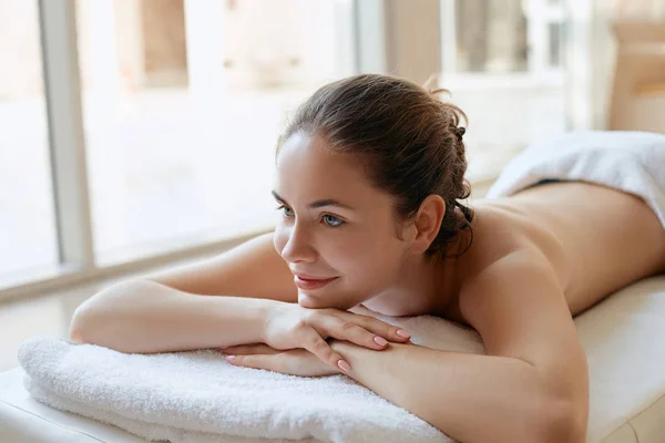 Beautiful woman  relaxing in spa salon. Spa Massage. Body care. Spa body. Cosmetology. Girl having massage in the spa salon