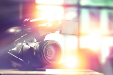 professional video camcorder in studio with blurred background for tv interview clipart