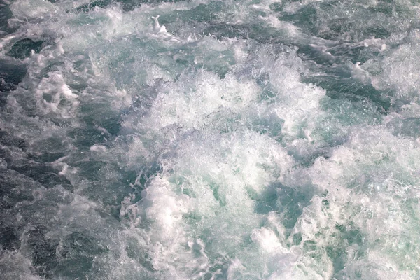 surface water waves texture, white foam of sea water waves background.