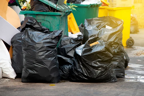 Pile of  black garbage bags at city street, waste management in large cities — Stock Photo, Image