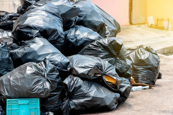 Pile of  black garbage bags at city street, waste management in large cities — Stock Photo, Image