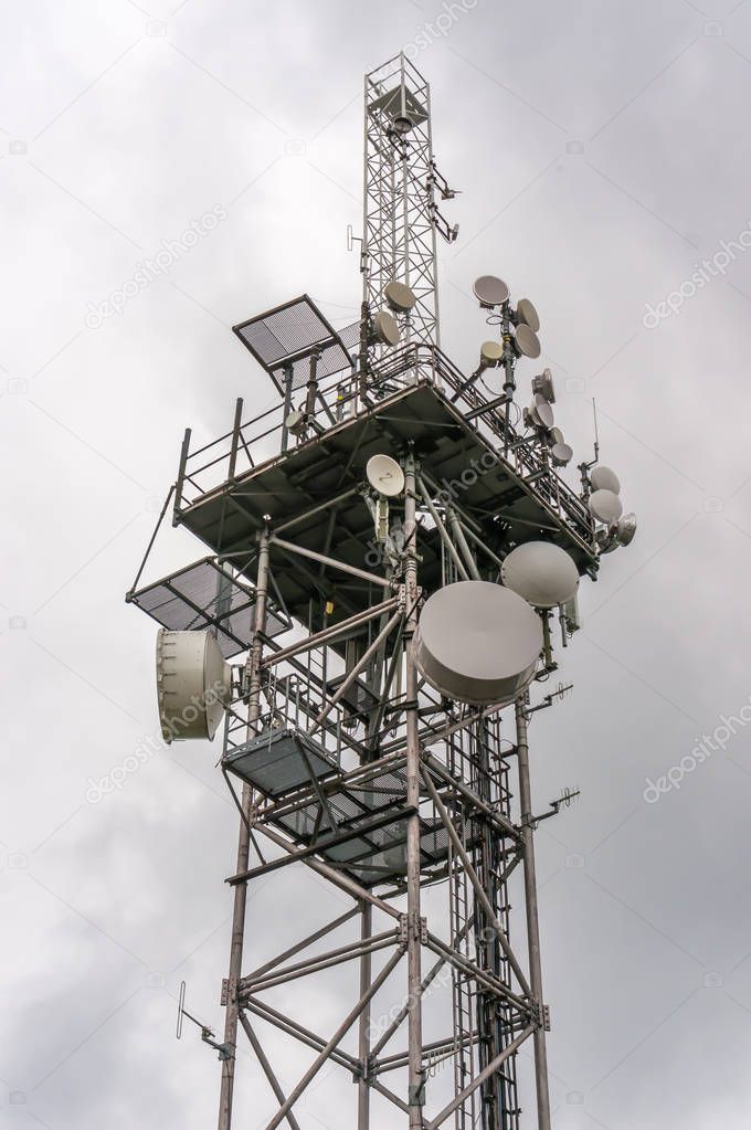 Telecommunication tower with transmitters antennas, satellite dishes and parabolas