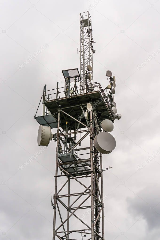 Telecommunication tower with transmitters antennas, satellite dishes and parabolas