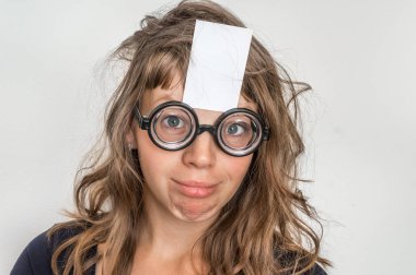 Alnında beyaz kağıt olan komik bir kadının portresi.