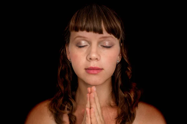 Young woman praying to god - spirituality concept