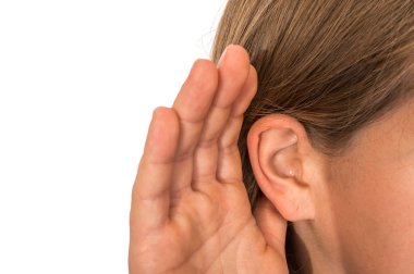 Woman is listening with her hand on an ear - hearing loss concept clipart