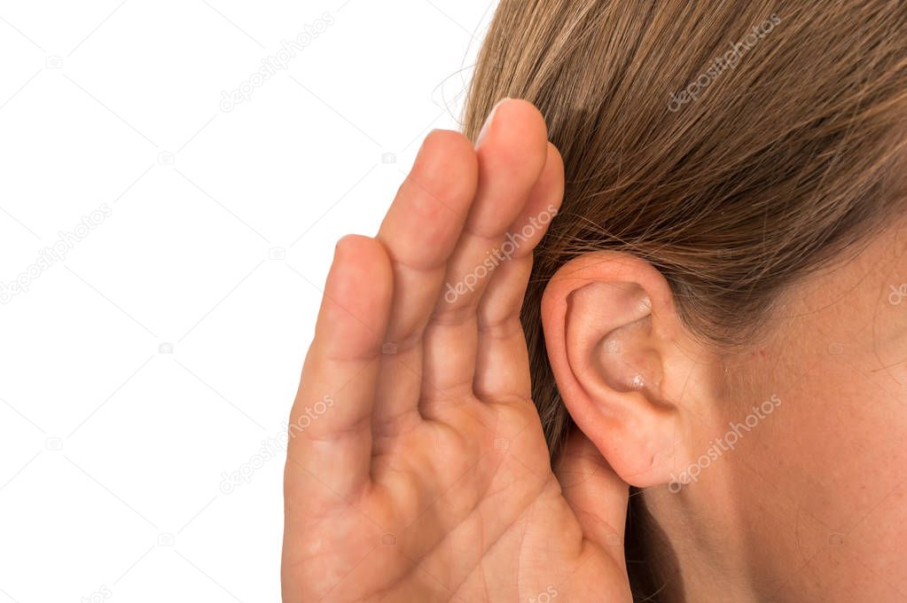 Woman is listening with her hand on an ear - hearing loss concept