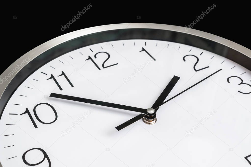 Close-up view of clock isolated on black - deadline and time concept