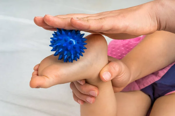 Mother Makes Foot Massage Her Baby Blue Massage Ball — Stock Photo, Image