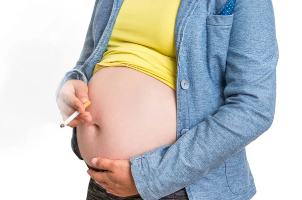 Pregnant unscrupulous woman with cigarette - smoking addiction concept