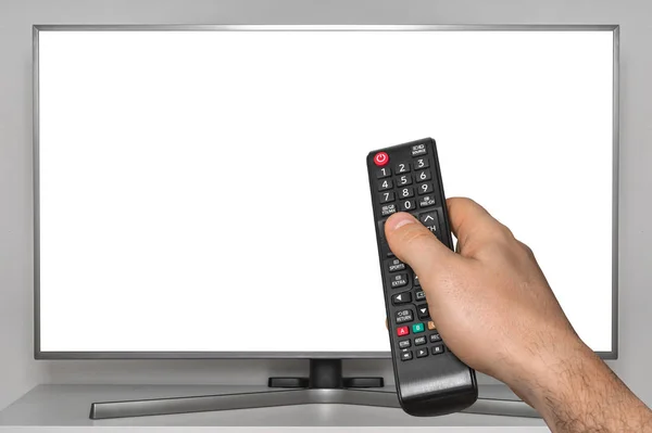 White screen on TV and human hand with TV remote control — Stock Photo, Image