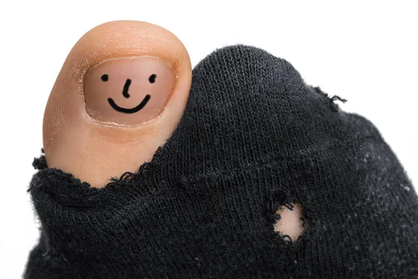 Sock with a hole and finger sticking out of them — Stock Photo, Image