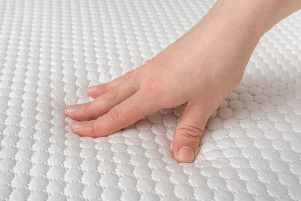 Woman is choosing new mattress for good sleeping