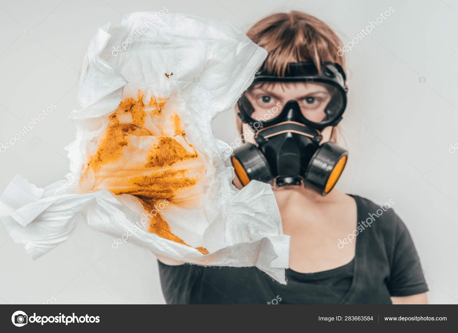 Mother with gas mask changing smelly diaper Stock Photo by ©andriano_cz  283663584