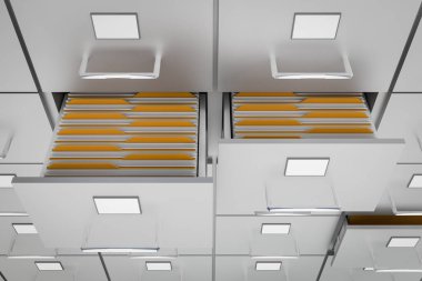 Açık bir çekmece sarı klasörlerle kabine dosyalama