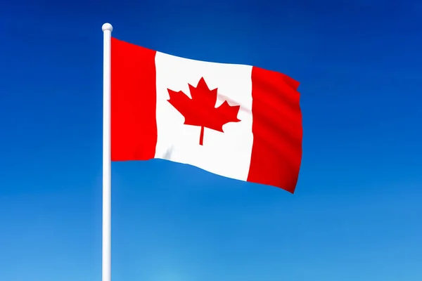 Vlající vlajka Kanady na pozadí modré oblohy — Stock fotografie